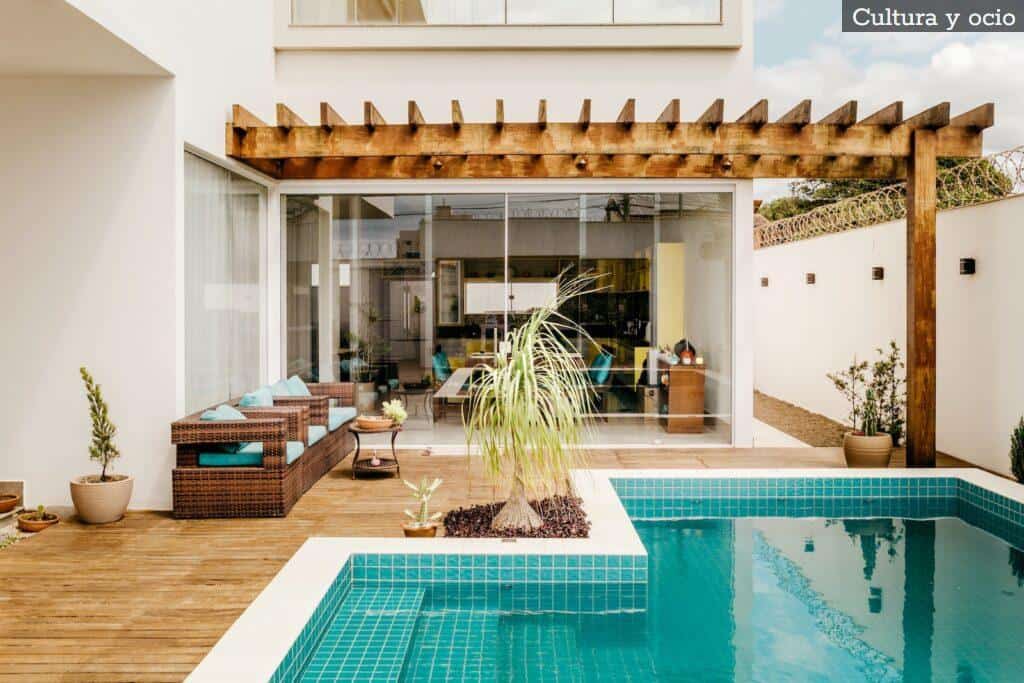 brown wooden table near swimming pool