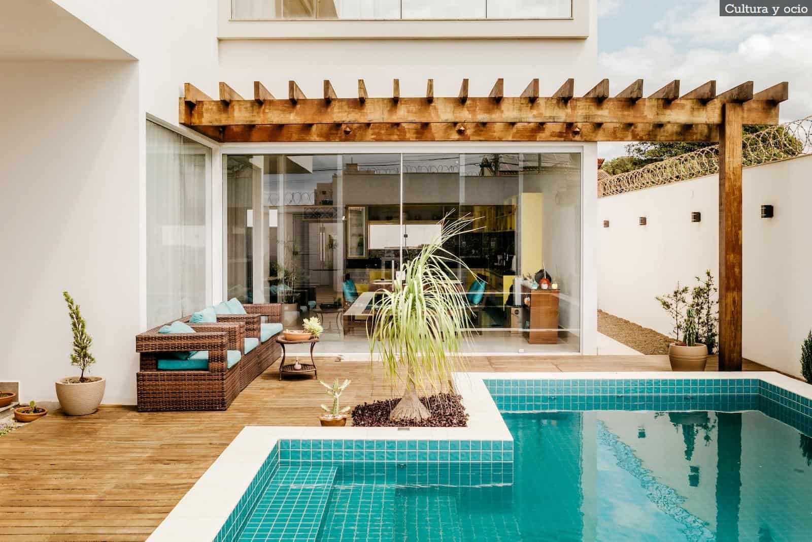 brown wooden table near swimming pool