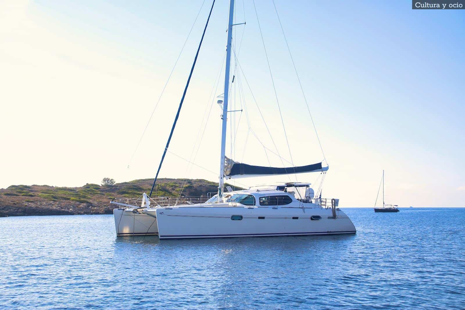 white and black sail boat on sea during daytime