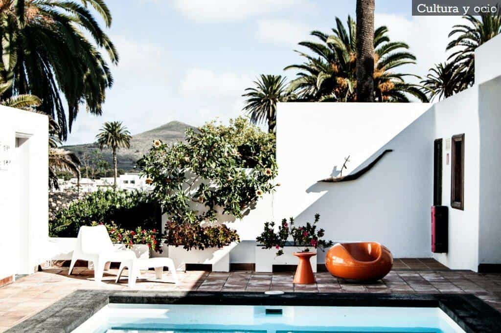white ceramic table with chairs near swimming pool during daytime