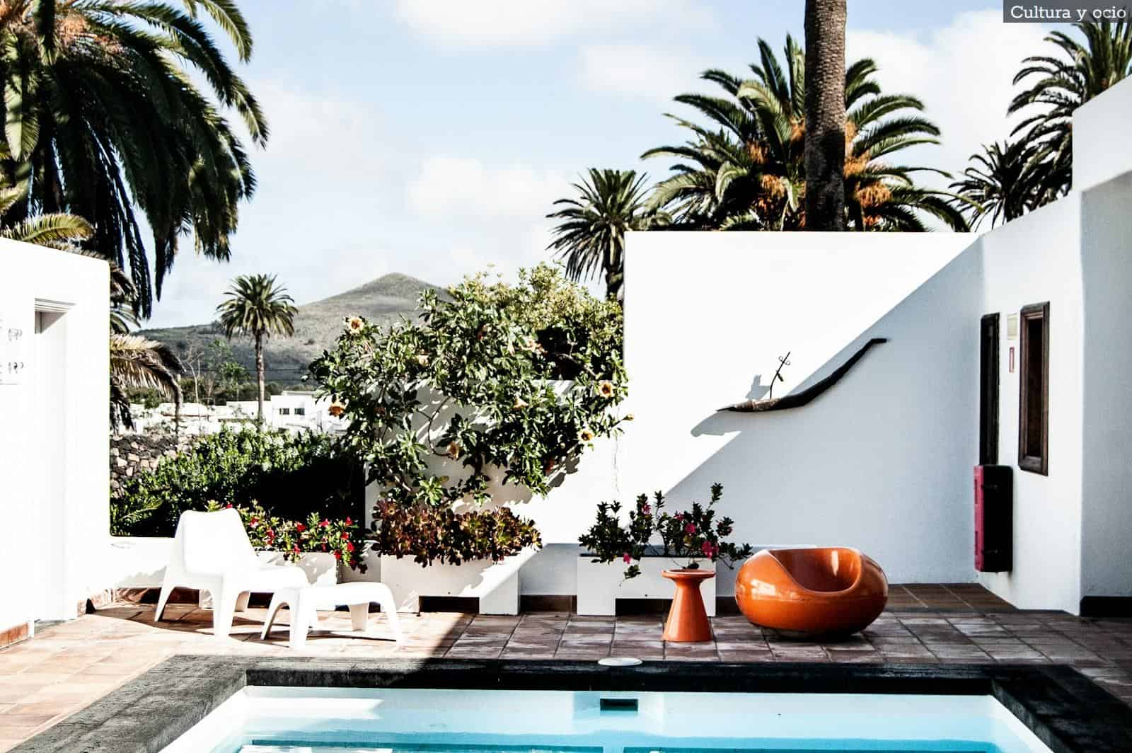 white ceramic table with chairs near swimming pool during daytime