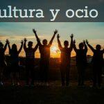 A diverse group of friends raises their arms in celebration against a vibrant sunset backdrop.