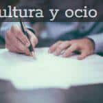 man writing on paper